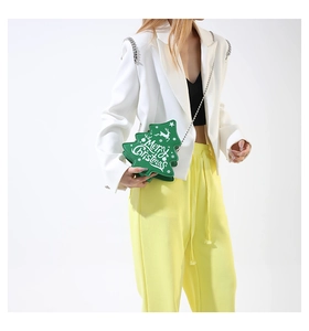 Unique green Christmas tree chain bag with Merry Christmas lettering on white blazer