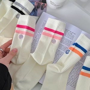 Off-white cotton crew socks with colorful stripes and smiley face embroidery