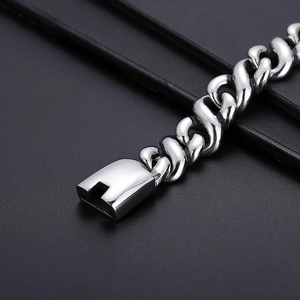 Macro shot of silver stainless steel Cuban chain bracelet with secure box clasp closure