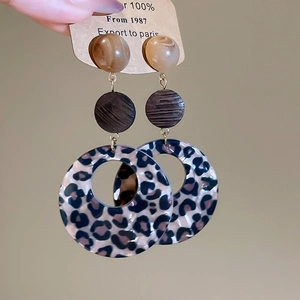 Three-tier leopard print acrylic drop earrings featuring brown marbled beads and wooden discs
