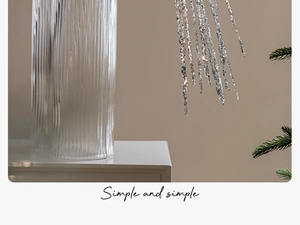 Silver sequin tassel Christmas branch decoration in a ribbed glass vase setup