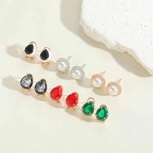 Close-up of various teardrop and round French vintage earrings in gold and silver settings