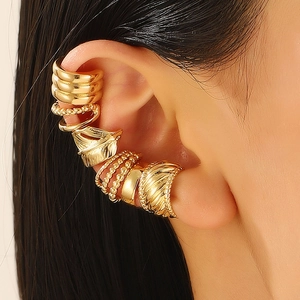 Set of vintage gold ear cuffs with textured and smooth finishes shown on female model