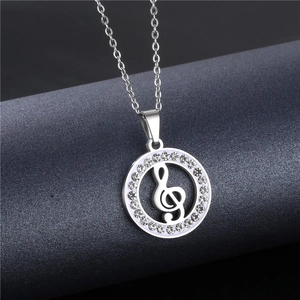 Macro view of silver treble clef pendant with crystal-encrusted hollow circle