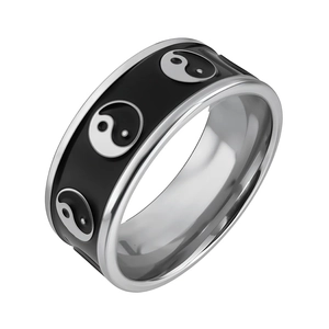 Macro shot of silver and black stainless steel ring featuring Tai Chi Yin Yang engraving