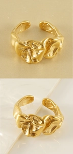 Macro shot of gold-plated irregular lava texture ring with artistic flowing metal design