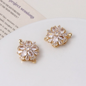 Macro view of gold zircon flower clasp with double loops for DIY jewelry making