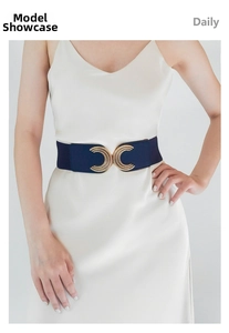 Detail of navy elastic waist belt featuring a textured golden interlocking double C buckle