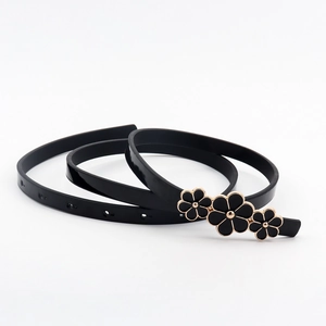 Close-up of black PU leather belt featuring three gold-edged floral buckle details