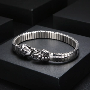 Macro shot of punk style double snake head clasp with scale texture on steel bracelet