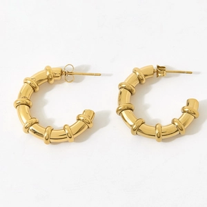 Polished gold-plated C-shaped hoop earrings with bamboo segment texture details
