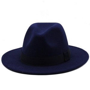 Macro view of navy wool fedora hat featuring a classic black grosgrain ribbon band