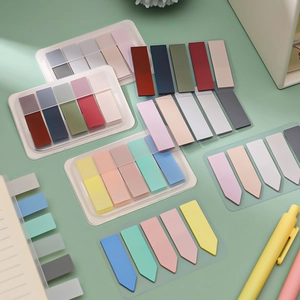 Morandi sticky notes and index tabs in various colors on a desk with stationery