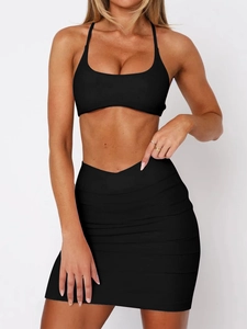 Detail of black sports yoga two-piece set featuring a bikini top and mini skirt