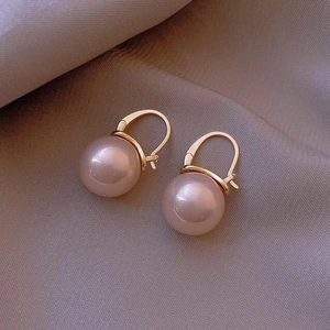 Elegant gold drop earrings featuring lavender round pearls on a grey silk background