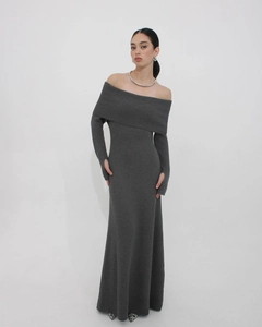 Detail of dark grey rib-knit dress featuring off-shoulder neckline and thumbhole cuffs