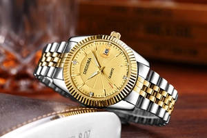 Macro shot of DEDIMA men's watch featuring a gold sunray dial with date display window