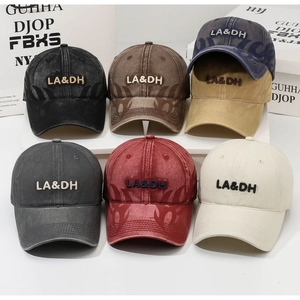 Detailed row of vintage washed baseball caps featuring 3D LA&DH embroidery and flame patterns