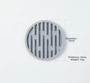 Detail view of a 10cm round light gray silicone coaster with 5mm thick anti-slip texture