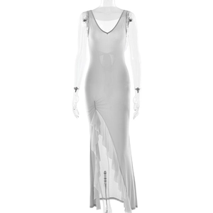 Elegant white sleeveless V-neck maxi dress with side slit and ruffled details