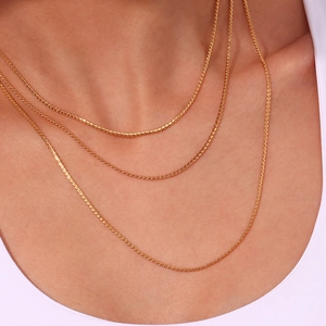 Three-layer 18K gold plated stainless steel necklaces styled in a layered fashion