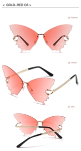 Detail view of gold-red butterfly rimless sunglasses with gradient lenses and chain arms