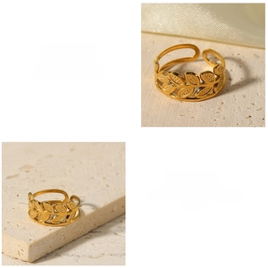 Macro detail of 18k gold plated stainless steel hollow leaf ring on stone base