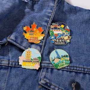 Set of 4 Nanjing landmark metal pins featuring Qixia Mountain and Jiming Temple on denim