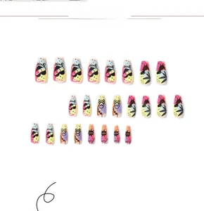 Pop art style press-on nails featuring smile, heart, and neon color block patterns