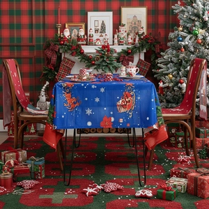 Blue Christmas tablecloth featuring Santa sleigh and reindeer patterns for holiday dining