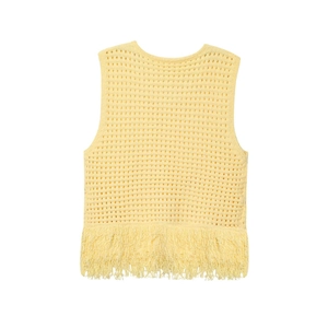 Détail du gilet en tricot jaune clair montrant le motif crochet et les longues franges