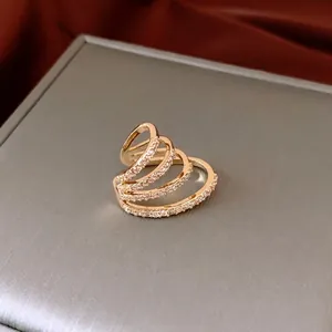 French style multi-layer gold plated ring with zircon stones on silk background