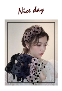 Close-up of elegant polka dot bow headbands in coffee, black, navy, pink and beige