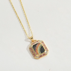 Detailed shot of golden rainbow necklace with rectangular pendant and pink gemstones