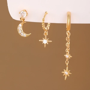 Detailed close-up of gold star and moon earring set featuring brilliant cubic zirconia