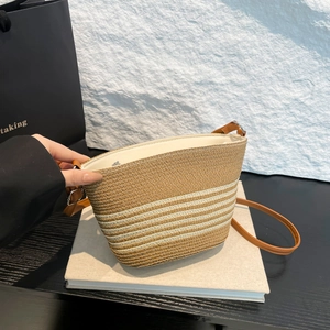 Straw striped bucket bag with brown leather strap for summer beach vacation style