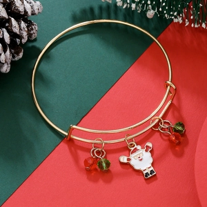 Macro detail of adjustable gold Christmas bangle with Santa Claus and festive beads