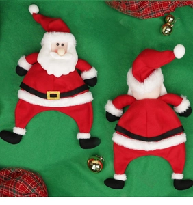 Detail view of mini Santa Claus wine bottle covers with belt buckle design and plush fabric