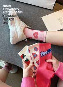Detail of pink cotton crew socks featuring strawberry prints and plastic embroidery detail