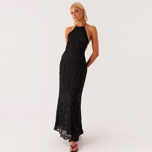 Detailed view of the fine pleated texture on a black halter-neck backless maxi dress