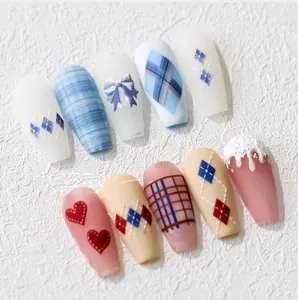 Detailed view of 5D embossed nail stickers featuring blue bows and plaid patterns
