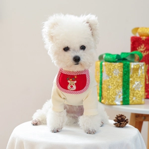 Detail of Christmas dog bib with reindeer embroidery on red plaid fabric and knit base