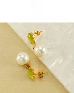 Detail view of water drop opal and pearl earrings with 18K gold vacuum plating finish