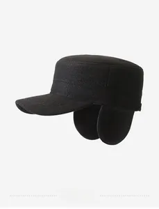 Detail view of winter black flat cap featuring side metal logo and warm ear protection