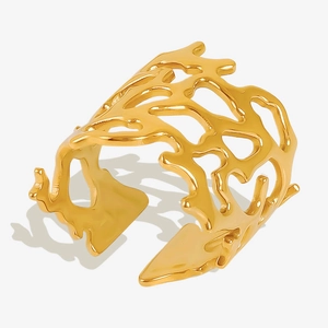Detailed view of wide gold coral style ring featuring irregular hollow mesh structure