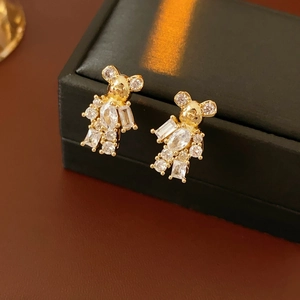 Macro shot of gold-plated bear stud earrings with sparkling clear cubic zirconia stones