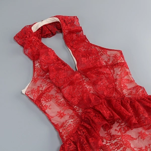 Detailed view of red floral lace fabric with ruffled trims on a backless halter dress