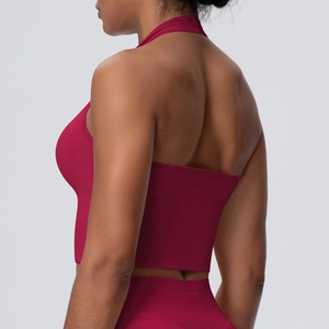 Detail view of backless halter yoga bra in rose red, showing seamless fit and skin texture