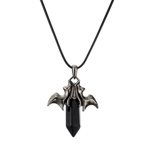 Detail of gothic bat wing pendant with black hexagonal crystal stone and silver metal