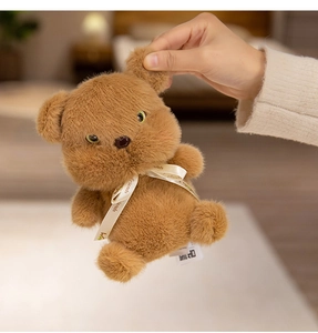 Close-up of a plush brown bear with a Friends ribbon and sparkling green eyes detail
